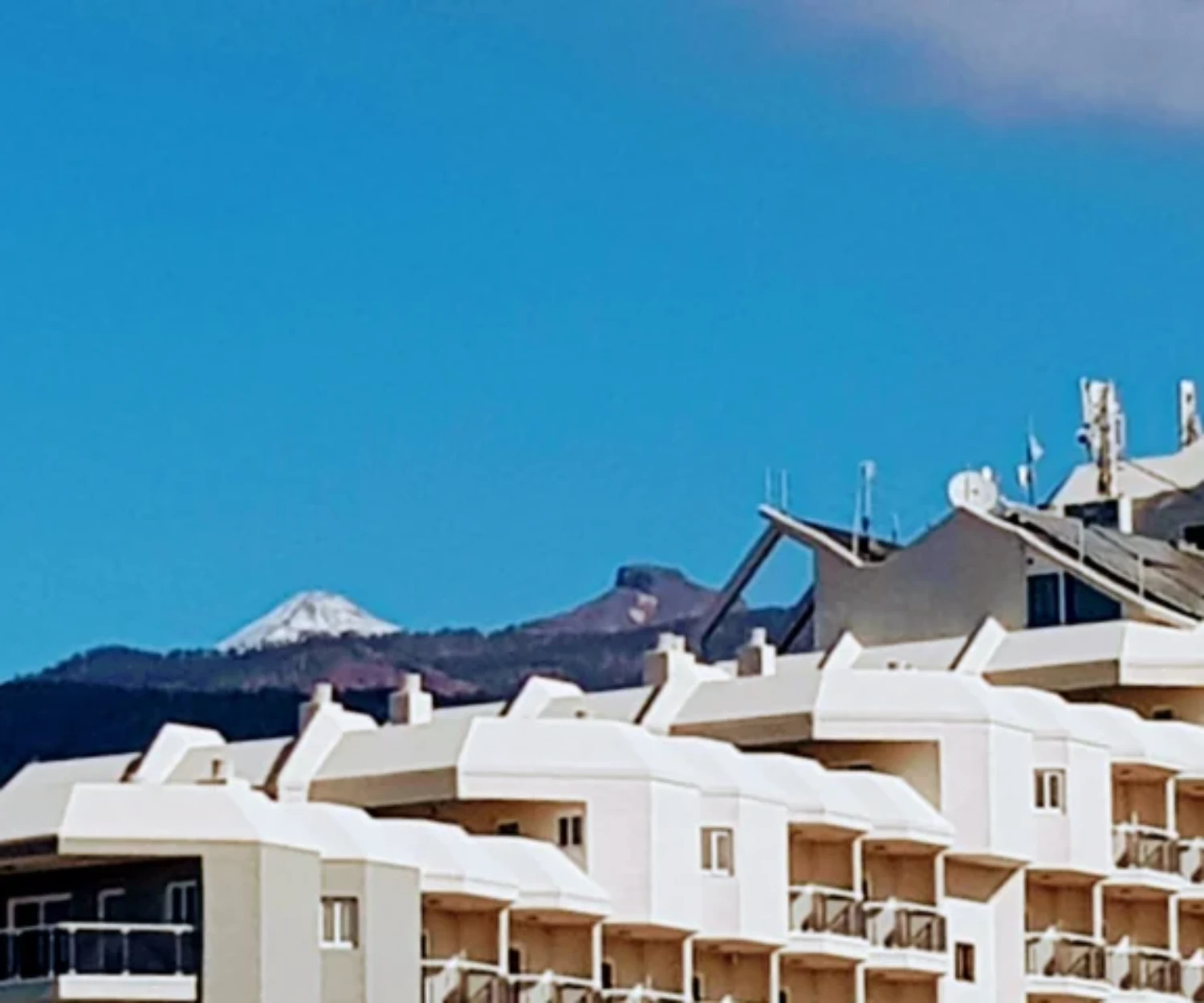 Older couple enjoying a sunny winter holiday on a Tenerife terrace